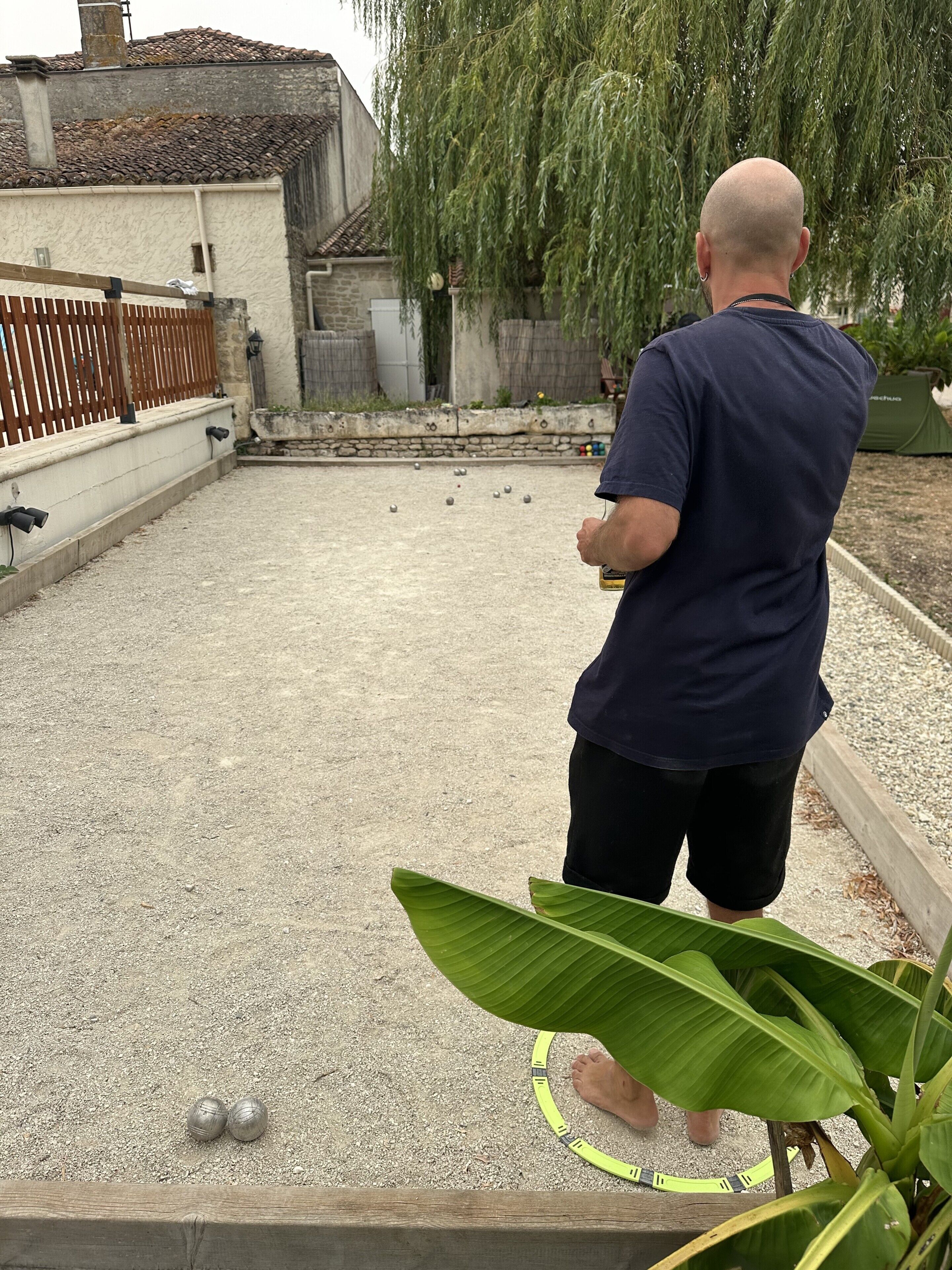 A person playing a lawn game with a ball and a net.