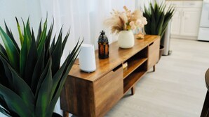A wooden console table with a white vase, a small black lantern, and a potted plant. - Private Pool Paradise Near Hard Rock & Beach (Hollywood)