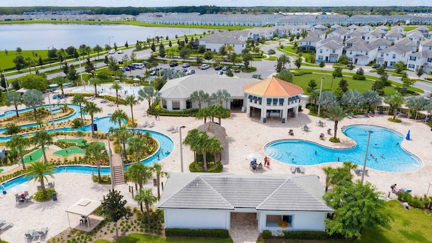 A resort with multiple swimming pools, a golf course, and a large building with a dome. - Storey Lake Home Pool 15min to Disney (Kissimmee)