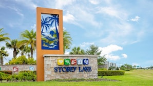 A sign for Storey Lake with palm trees and a beach scene. - Storey Lake Home Pool 15min to Disney (Kissimmee)