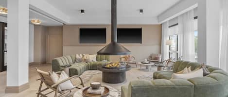 Ein geräumiges Wohnzimmer mit großem Kamin, bequemen Sitzmöglichkeiten und modernem Design.