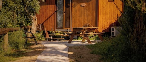 A wooden cabin with a door, a window, and a sign labeled 'PASTOR'.