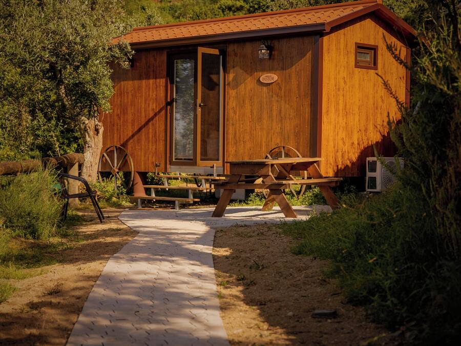 A wooden cabin with a door, a window, and a sign labeled 'PASTOR'.