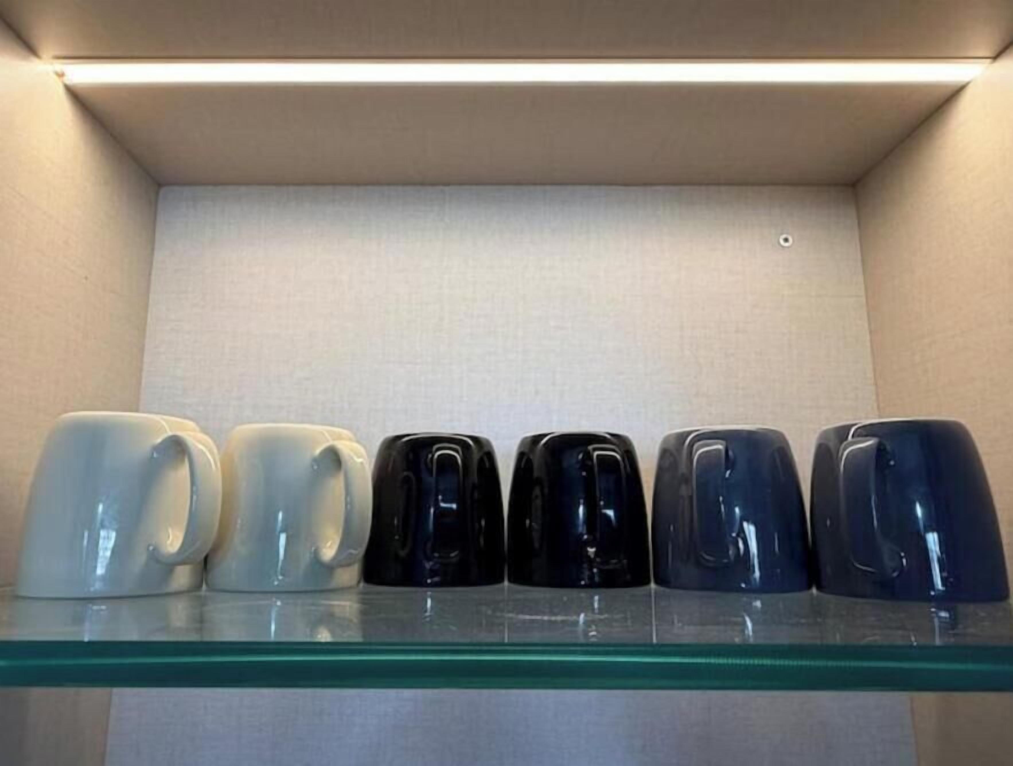A display of mugs on a shelf.