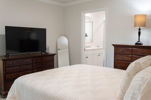 A bedroom with a bed, dresser, television, and a lamp. - Beautiful Palm Coast Escape Near Beaches (Palm Coast)