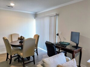 A dining area with a round table, chairs, and a small decorative bowl. - Beautiful Palm Coast Escape Near Beaches (Palm Coast)