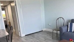 A living room with a dining table, chairs, a sofa, and a coffee table. - At the heart of Myrtle Beach Oceanfront Condo (Myrtle Beach)