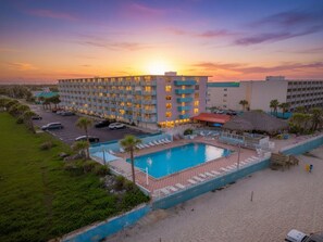 A hotel with a swimming pool, multiple balconies, and a beachside location. - Top-Floor Oceanfront Suite • Sleeps 6 (Daytona Beach)