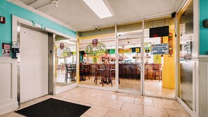 A restaurant entrance with a sign for 'Oasis' and a 'No Outside Exit' sign.