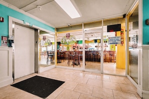 A restaurant entrance with a sign for 'Oasis' and a 'No Outside Exit' sign.