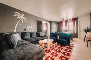 A living room with a sofa, armchairs, a coffee table, and a patterned rug. - Top-Floor Oceanfront Suite • Sleeps 6 (Daytona Beach)