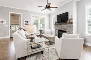 A modern living room with a fireplace, seating, and a television. - The Retreat, 3BR Wlk-SQ+grill by Velvet Ditch Villas (Oxford)