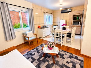 Ein kompakter Wohnbereich mit Küchenzeile, Essplatz und Schlafzimmer.