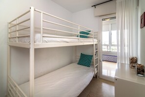 A bunk bed room with a window and a door. - LXR La Carihuela Sea Views 3-Bedroom (Torremolinos)