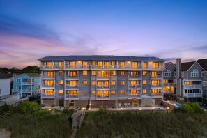 A multi-story hotel with balconies, a swimming pool, and a beach view. - Oceanfront 2BR Condo | Balcony, Pool — Surfside Beach, SC (Surfside Beach)