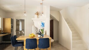 A modern kitchen with a wooden island, bar stools, pendant lights, and a staircase. - Family domaine with pool in the Camargue region (Arles)