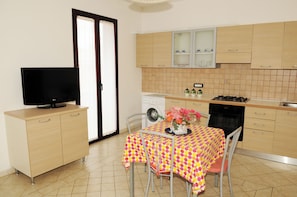 Apartment, Garden View | Private kitchen | Full-sized fridge, oven, stovetop, cookware/dishes/utensils