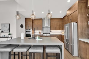 A modern kitchen with a central island, stainless steel appliances, and pendant lighting. - 3BR Park City View Home | Hot Tub | Pet-Friendly (Hideout)