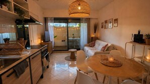 A modern kitchen with a dining area, a large window, and a ceiling light fixture. - 2-Bedroom Apartment with Private Terrace · Pool · 50m from the Beach · Parking (Villeneuve-Loubet)