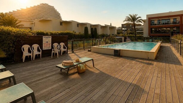 A rooftop pool area with a pool, lounge chairs, and a wooden deck. - 2-Bedroom Apartment with Private Terrace · Pool · 50m from the Beach · Parking (Villeneuve-Loubet)