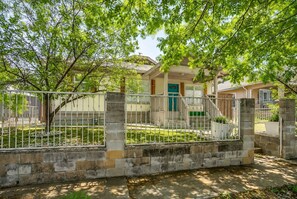 A residential area with a gated entrance, a staircase leading to a house, and a well-maintained lawn. - Spacious Dallas Home + Guest House | Sleeps 21 (Dallas)