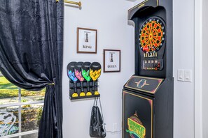A dartboard, a set of colorful paddles, and framed chess pieces labeled KING and QUEEN. - 12 BR Estate!•HeatedPool • Pickle • GameRm •Events (Clearwater)