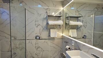 A modern bathroom with a toilet, bidet, and a large sink.