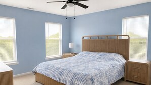 A bedroom with a bed, nightstands, a ceiling fan, and two windows with blinds. - New 3BR Wildwood Condo • Sleeps 8 • Garage • Walk to Beach (Wildwood)