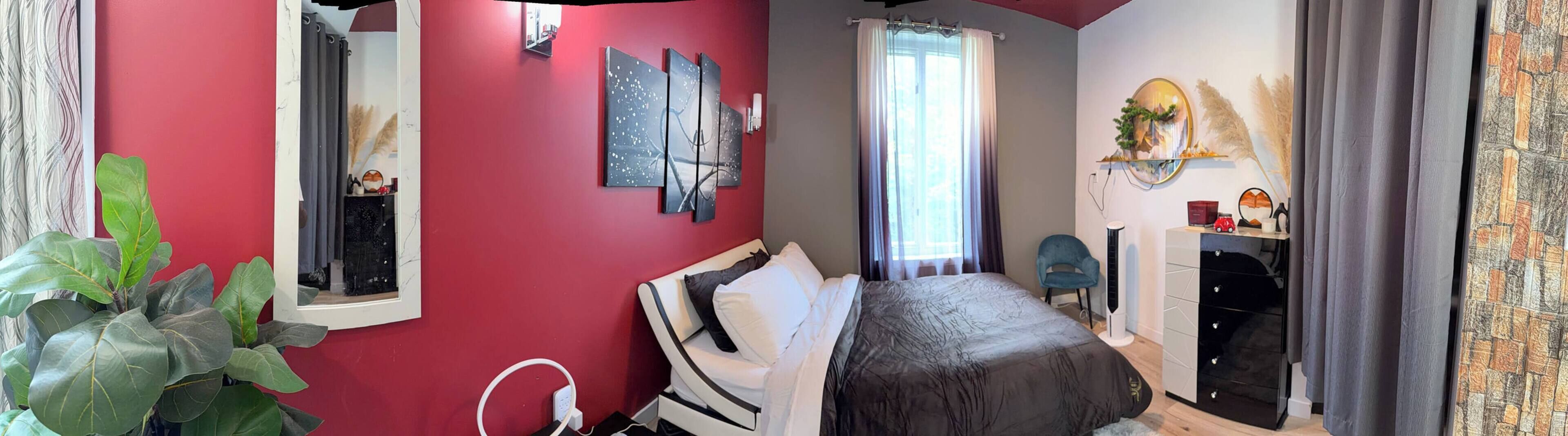 A bedroom with a bed, a dresser, a chair, and a window with curtains.