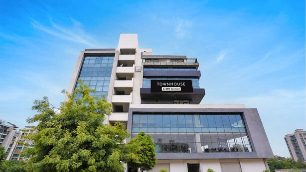 A multi-story building with a sign indicating it is a serviced apartment.