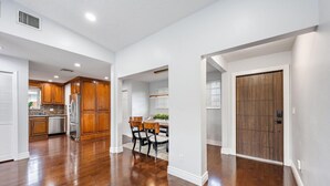 A spacious kitchen with wooden cabinets and a stainless steel refrigerator. - `Once upon a Tide`  North Palm 3BR/2B/Heated Pool (North Palm Beach)