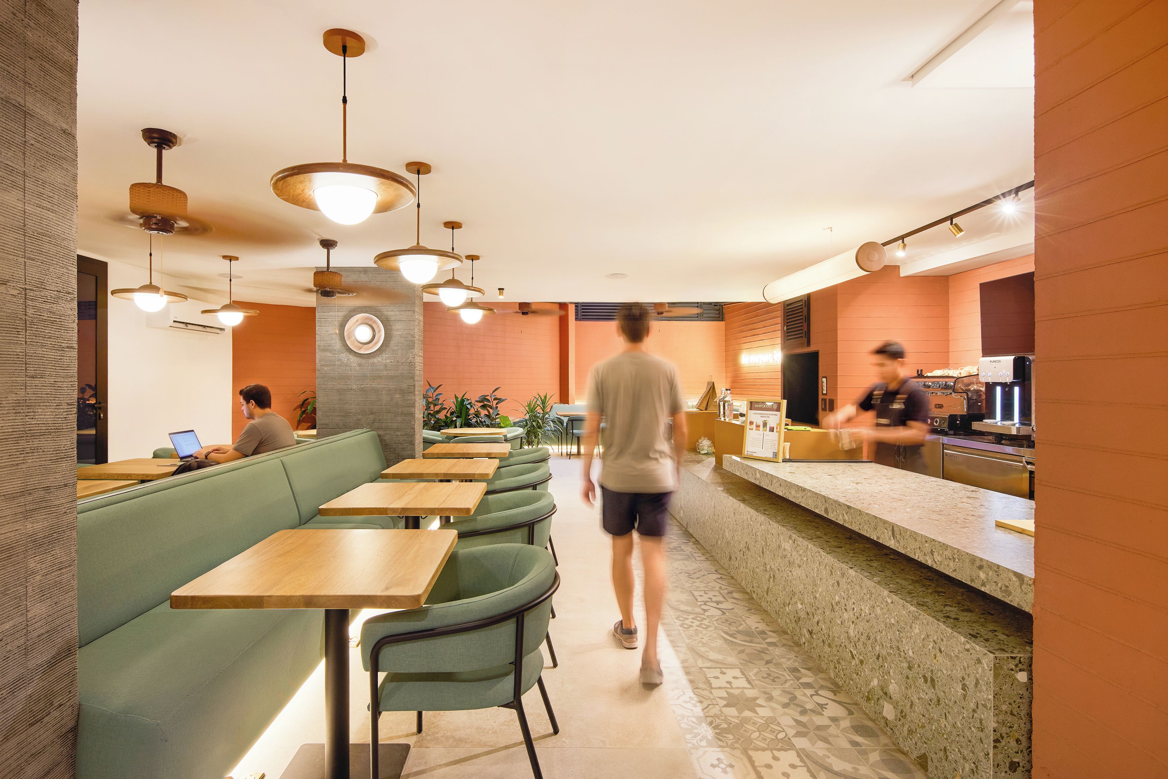 A restaurant interior with booths, tables, and a bar area.