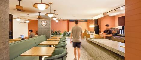 A restaurant interior with booths, tables, and a bar area.