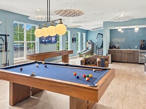 A pool table with balls, a sofa, and a kitchen area with cabinets and a refrigerator. - Resort-Style 2BR/2BA Mins to Universal & Disney! (Orlando)