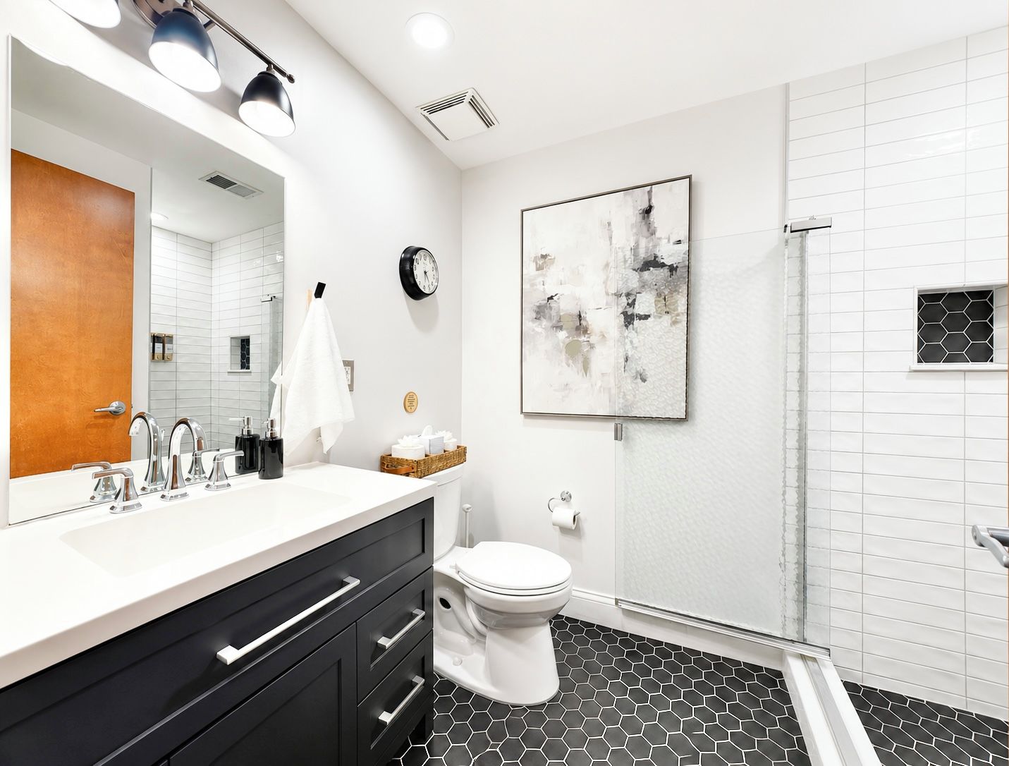 Fresh, modern, and beautifully updated, this spa-inspired bathroom features a walk-in tiled shower and upscale finishes for a refreshing start or end to your day.