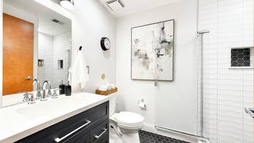 Fresh, modern, and beautifully updated, this spa-inspired bathroom features a walk-in tiled shower and upscale finishes for a refreshing start or end to your day.