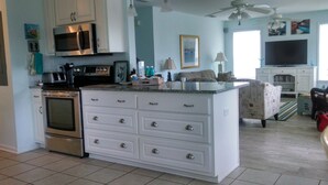 A kitchen with white cabinetry, a built-in oven, and a microwave. - Paradise Point 3 BR home overlooking the bay in gorgeous Saint George Island (Saint George Island)