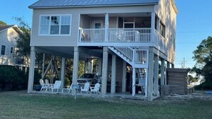 A two-story house with a balcony, a covered porch, and a car parked in the driveway. - Paradise Point 3 BR home overlooking the bay in gorgeous Saint George Island (Saint George Island)
