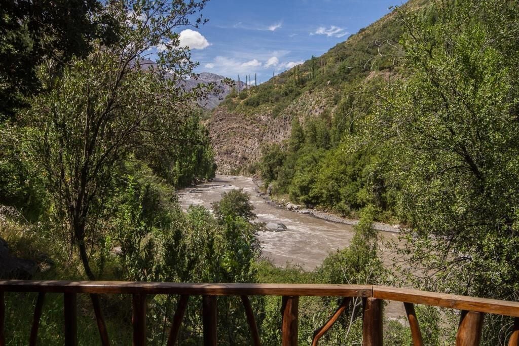 A river flowing through a mountainous landscape with dense greenery on both sides.