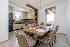 A modern kitchen with a dining area. - Villa ADRIA MOMENTS with private pool (Pinezići)