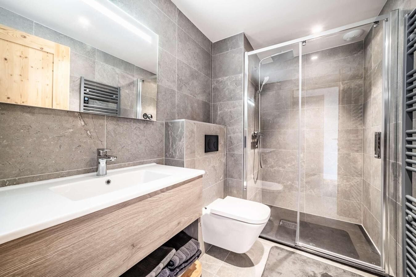 Une salle de bain moderne avec un grand lavabo, des toilettes et une douche à l’italienne.