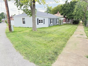A residential house with a sloped roof, a front yard with grass, and a sidewalk. - Mins To Zoo Anheuser Brewery Childrens Hospital (St. Louis)