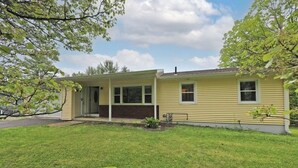 A single-story house with a front porch, a garage, and a well-maintained lawn. - Visit us 3 minutes from Tanglewood music hall and Kripalu Yoga Center (Lenox)