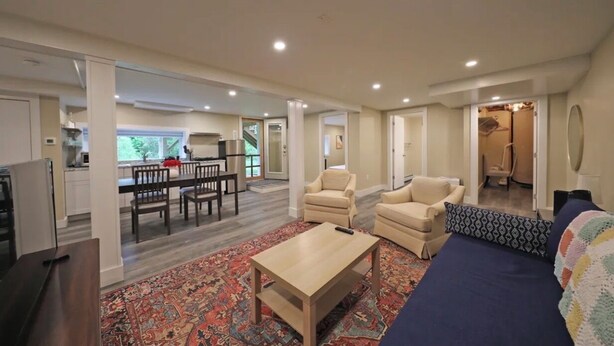 A spacious living area with a sofa, armchairs, a coffee table, and a dining area with a table and chairs. - Visit us 3 minutes from Tanglewood music hall and Kripalu Yoga Center (Lenox)