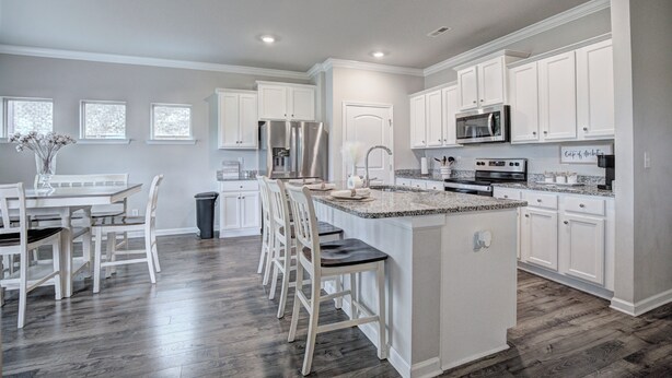 A modern kitchen with white cabinetry, a central island, and a dining area with chairs. - Marvelous 4-bedroom house, 5 miles from the square in vibrant Athens (Athens)