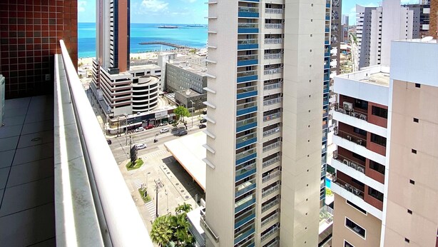 A high-rise building with multiple floors, a clear view of the ocean, and a cityscape in the background. - Modern apartment in Meireles • Modern Apartment near Beira Mar (Fortaleza)