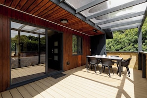 Outdoor dining - Riverside lodge with spacious decking, Ninja BBQ, Wi-Fi, Netflix-ready TV, EV charging and an outdoor copper bath and shower for a wellness experience in nature. Up to three well-behaved dogs are welcome in selected lodges. (Cornwall)