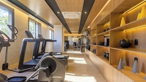 A gym with treadmills, exercise balls, and weights on wooden shelves. - Studio in Condo. at Bela Vista With gym Hmj0505 (São Paulo)