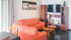 A living room with a sofa, a television, a cabinet, and a small table. - Brisa del Mar Vélez-Málaga by Ruralidays (Málaga)