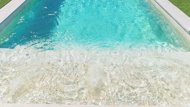 A clear swimming pool with a visible waterline and a concrete edge. - Puerta Encina Olvera by Ruralidays (Cádiz)
